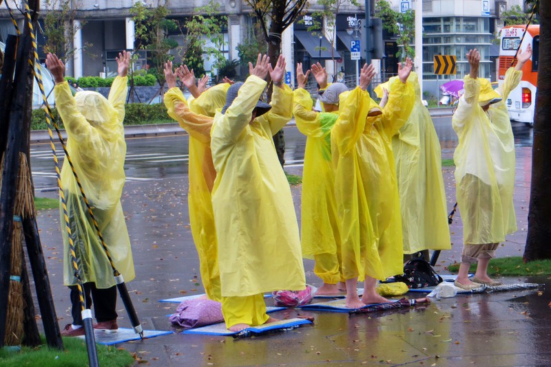 Exercising in the rain on the square of Taipei 101