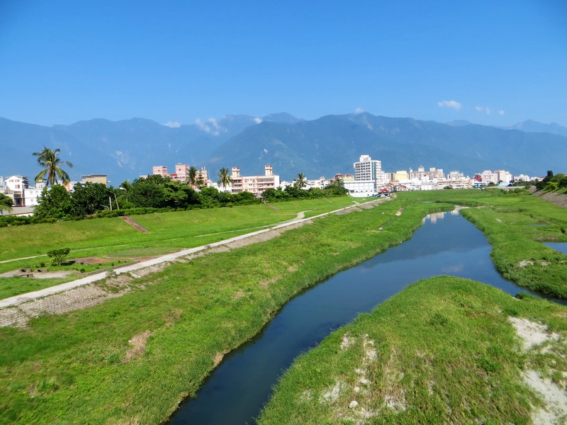 Bicycle path following the narrow band of water in the  river bed , Hualien