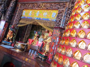 Temple altar - the tiny gold Buddhas on the right of the photo are purchased by the public