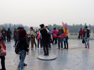 Testing the acoustics in the centre of the marble floor of the Round Altar within the Temple of Heaven complex.