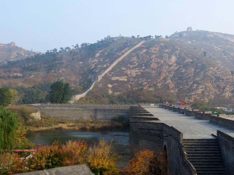 The unrestored section of the wall on the opposite side of the river