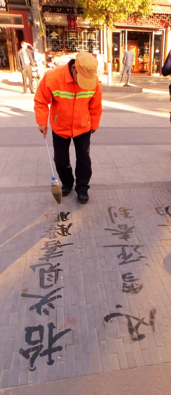 Practising calligraphy with water in square in Datong
