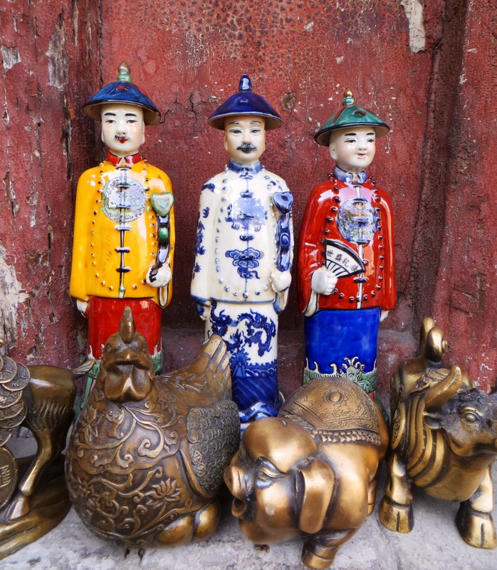 Three ceramic figures in the shop at the Hanging Monastery