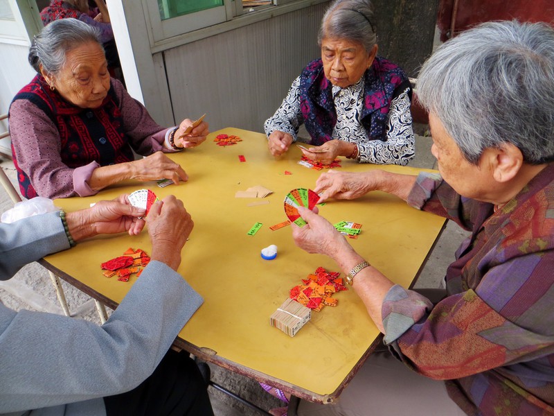 Old ladies playing cards within the temple grounds