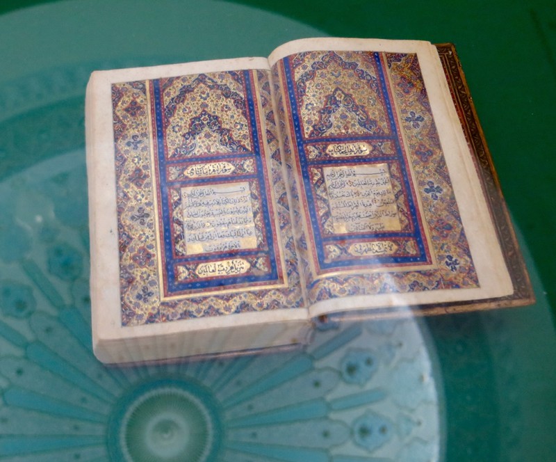Ancient Koran and reflectionof the domed roof of the Islamic Arts Museum