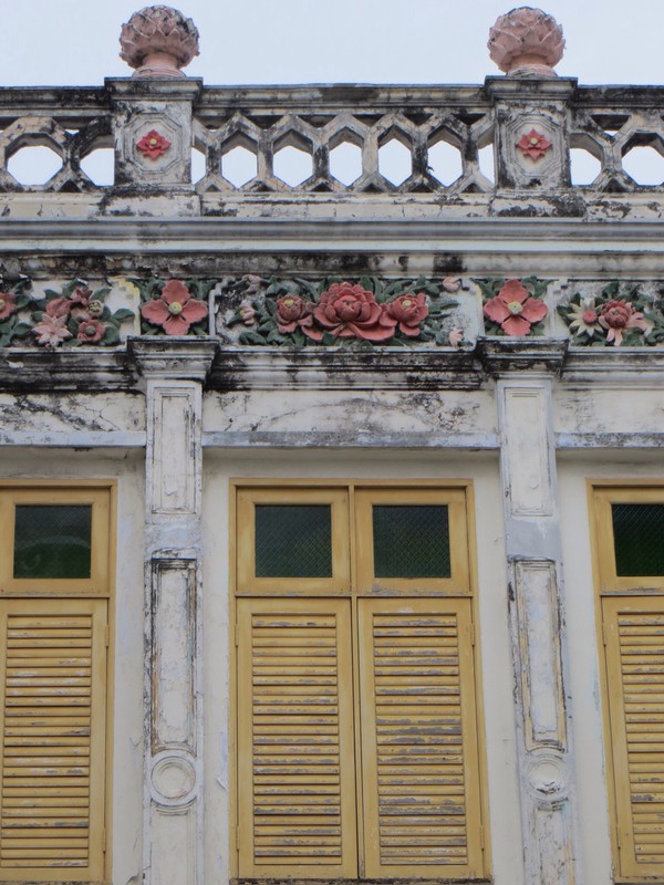 Shutters and dirt grimed flowers
