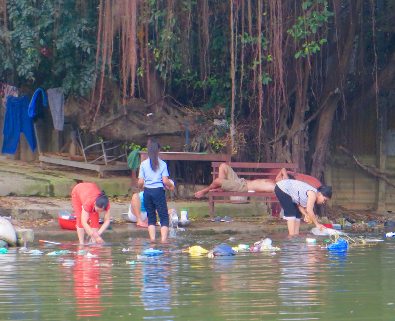 Washing clothes in the waters of the Perfume River