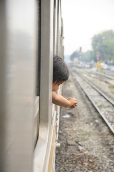 little boy hanging out the train window