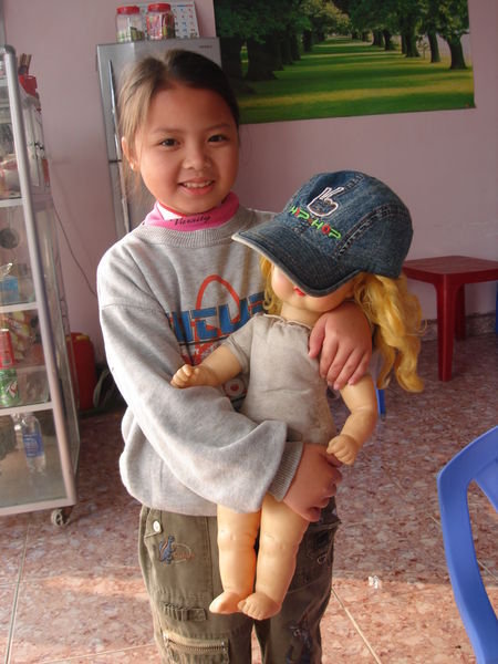 A kid with a blonde haired doll