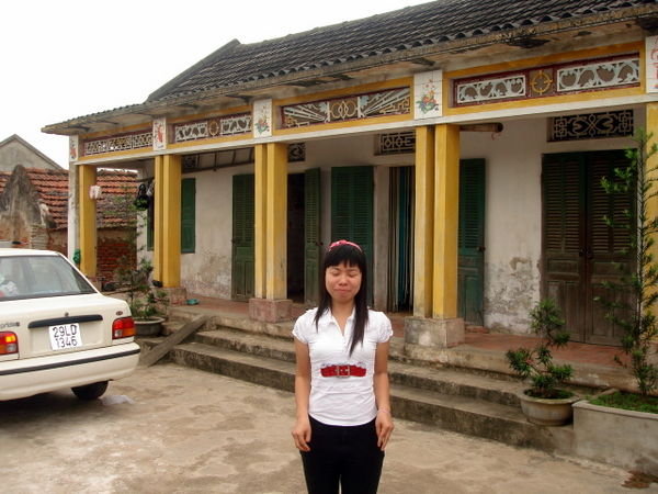 Loannie in front of their house