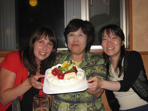 Three of the birthday gals show off the cake!
