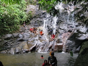 Kids frolic in the waterfall