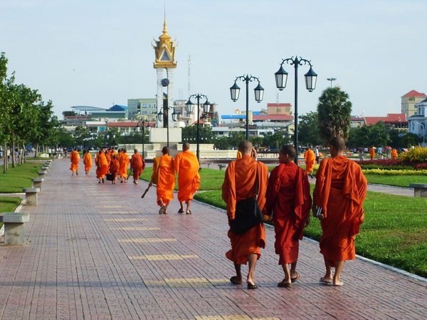 Modern Monks; the left one is on his cellphone and carrying a laptop