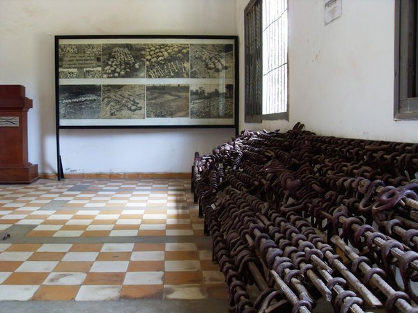 A picture of some of the mass graves that were discovered, on the right are the iron bars that prisoners were shackled to in groups.