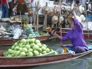 A long tail boat full of fresh apples on the floating market