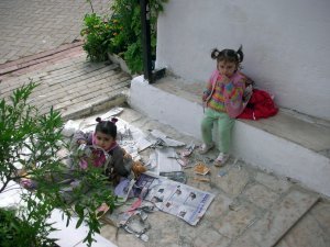 Kids eating newspaper, unsupervised by parents