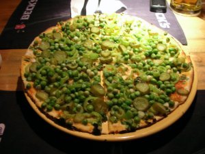 Yummy pizza with gherkins and peas, and nothing else