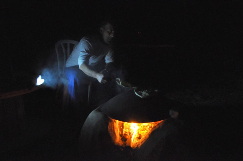Laurent baking pita on an open fire