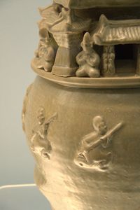Greenware jar with modeled human figurines and buildings