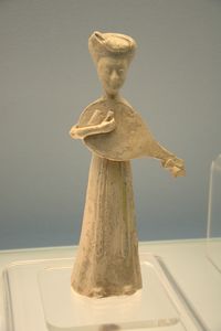 White-glazed pottery figurine of woman playing Pipa (lute)