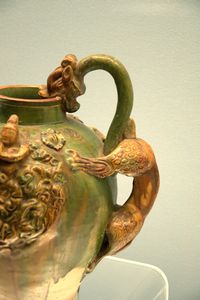 Polychrome-glazed pottery pitcher with a dragon head and applied design