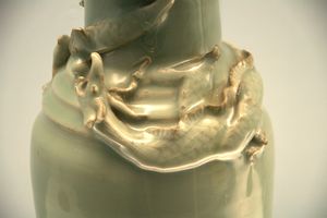 Celadon covered vase with modeled coiled dragon