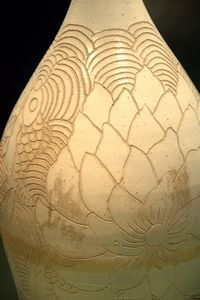 White-glazed vase with incised lotus and fish design