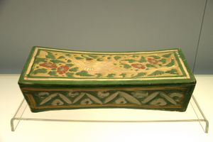 Polychrome-glazed pottery pillow with incised bird and flower design