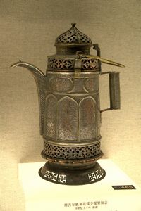 Uygur copper pitcher with an openwork design and a looped handle