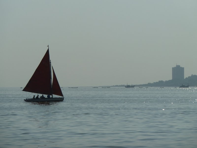 Red sailboat in the Mumbai harbor