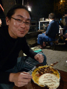 Clement enjoying meat on sticks in the Muslim Quarter