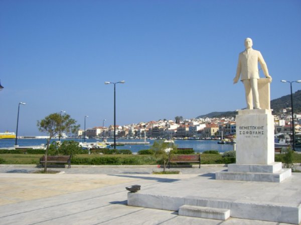 A statue and the town of Samos