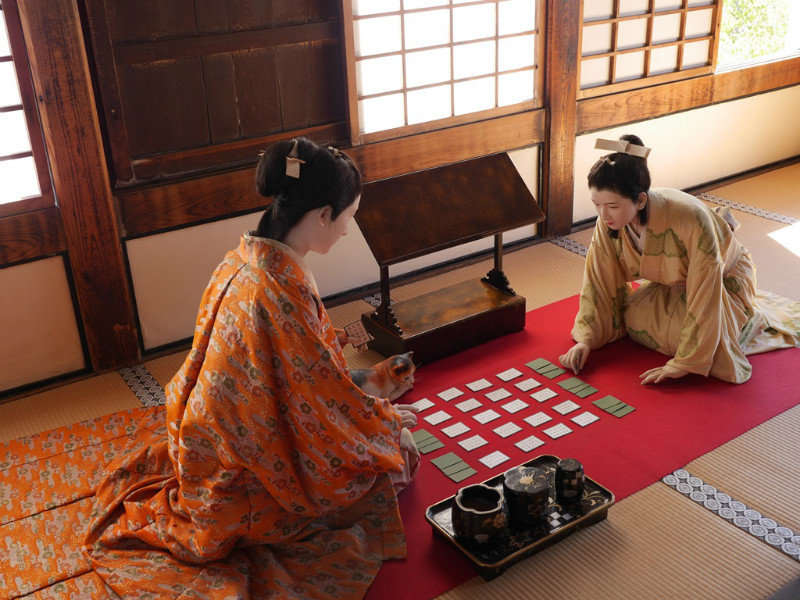 The princess plays cards with her handmaiden