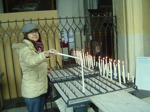 Lighting a candle in the church
