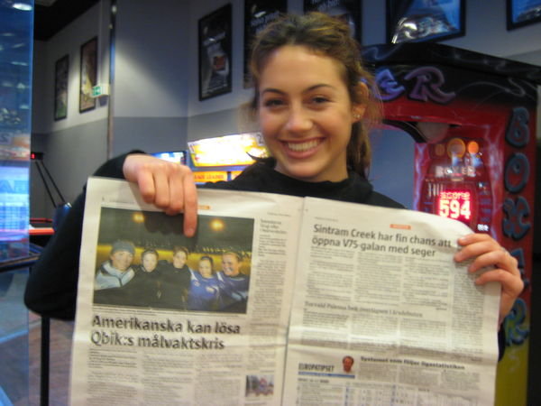 Shana pointing herself out in the paper