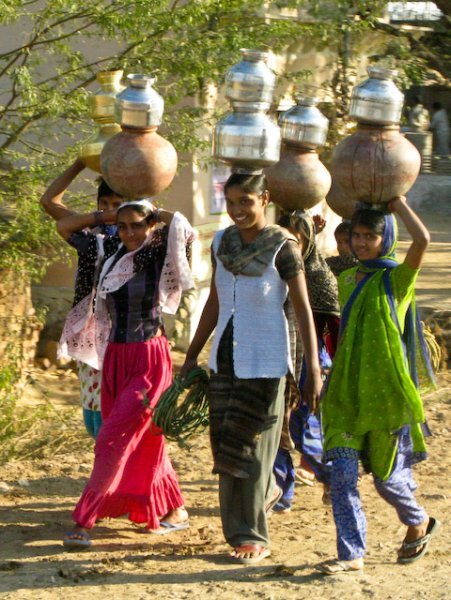 Happy group carrying water