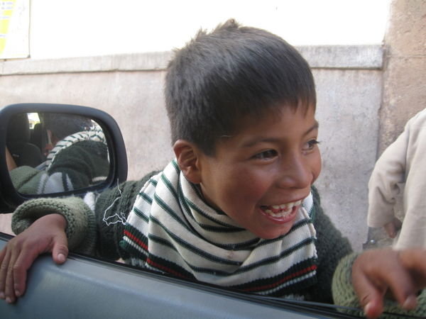 Cute Peruvian boy fascinated with Hotel Toyota