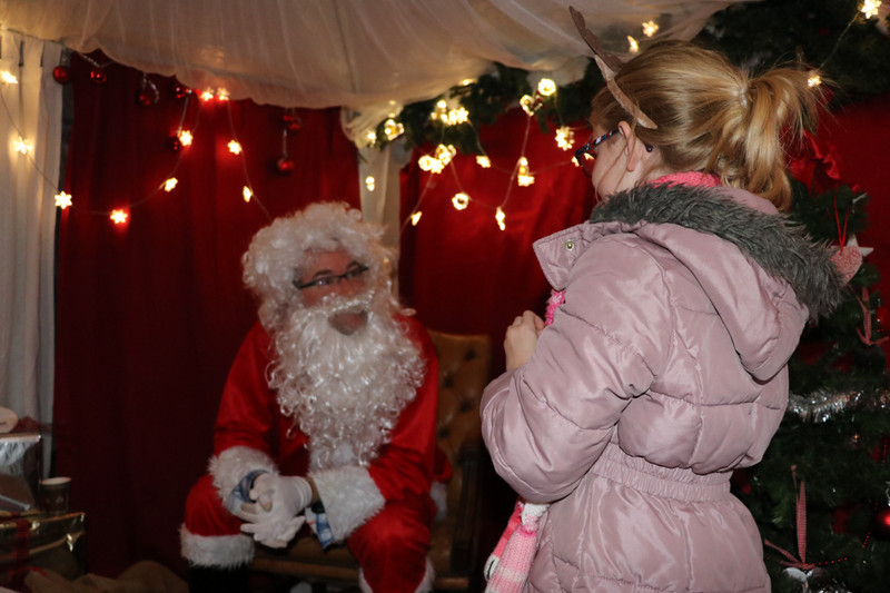 Emma chating to Santa at the Christmas fair