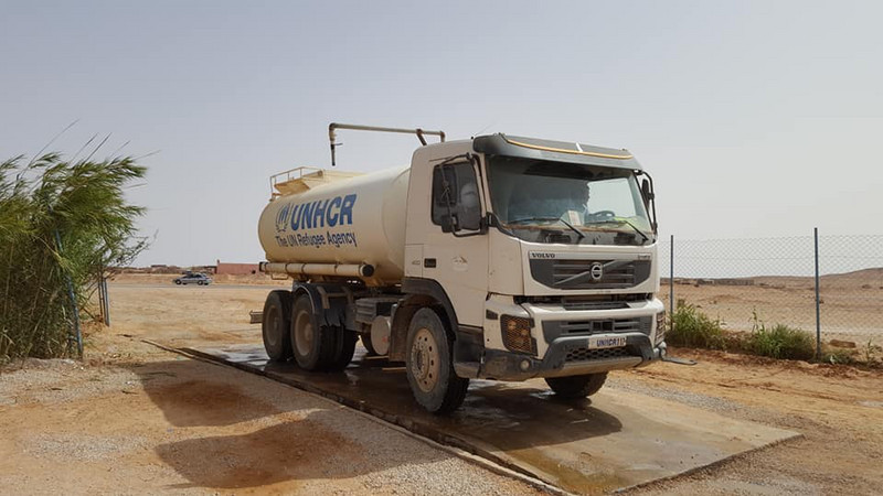 Water truck refilling station ready to deliver water to refugee communities