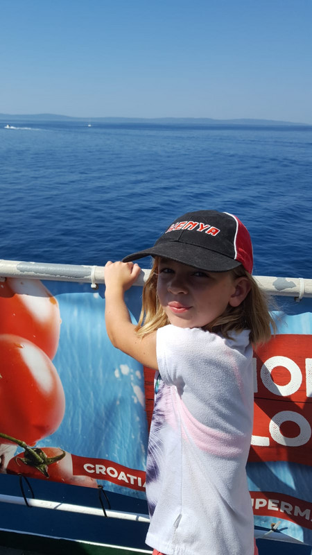 Emma enjoying being up on the deck, boat to Brac