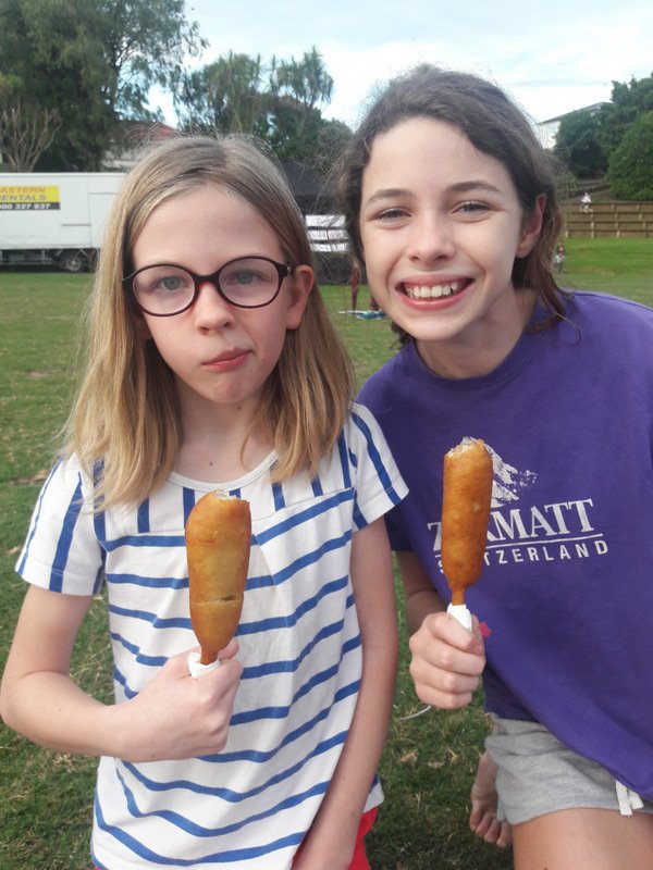 Girls first hot dog on a stick