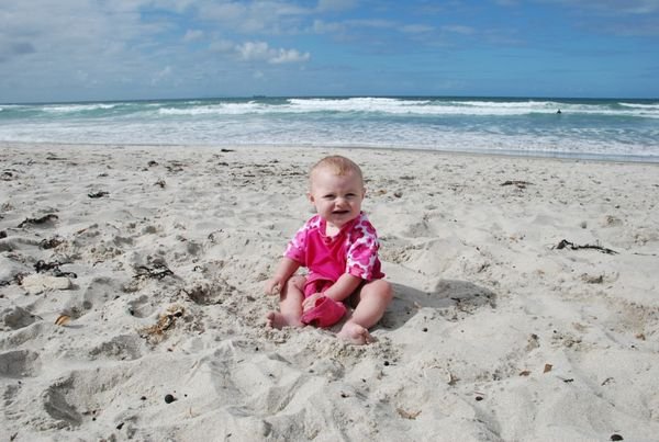 Charlotte enjoying the sand at Tauranga