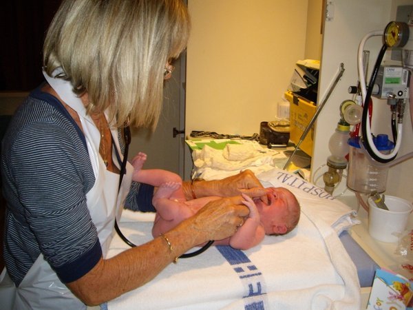 Hayley minutes old, being checked by the midwife