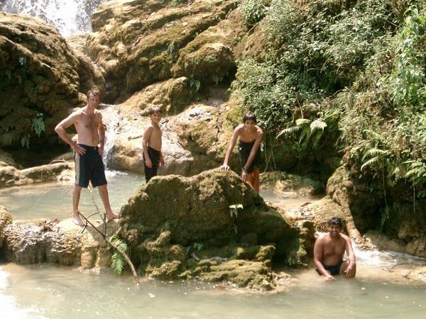 The boys swimming at the top of the Tat Kuang Si Waterfall.