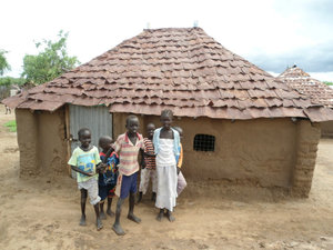 Sudanese refugees outside their home