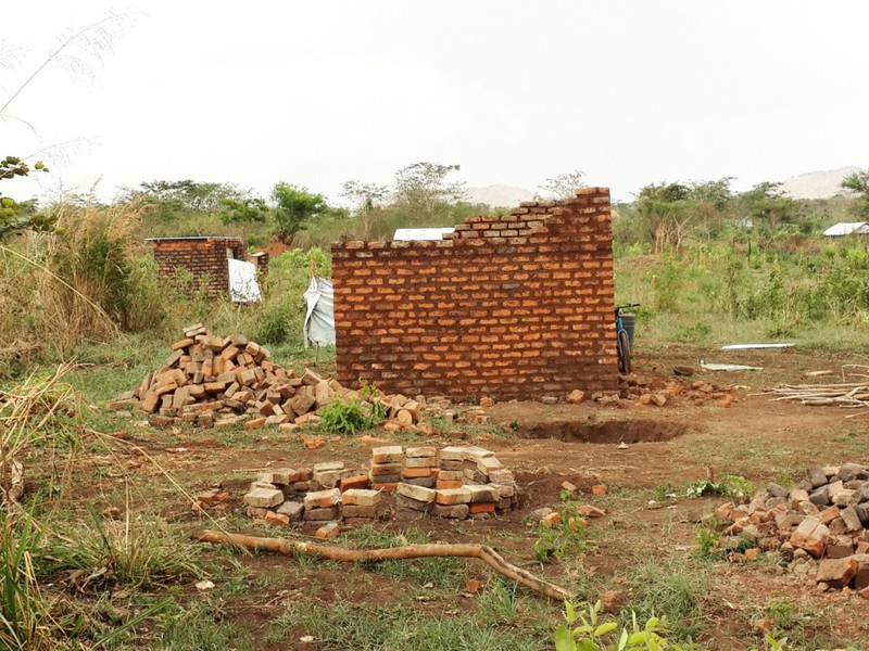 Refugees engaged contractors to build  their new brick houses in Uganda