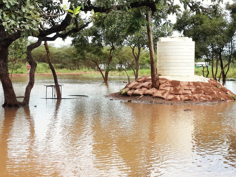 Sand bags protecting the water tank from flood erosion
