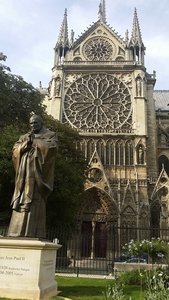 Side of the Notre-Dame with a sculpture of the pope beside