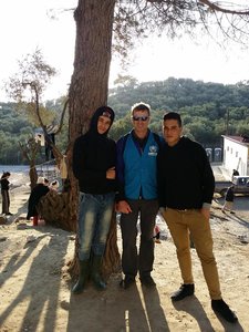 Two young Syrian refugees requested a photo with the engineer on site supervising construction projects at Moria