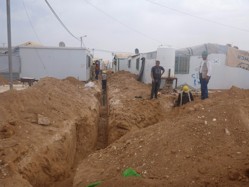 Installing waste water sewer pipe line Zataari camp Jordan
